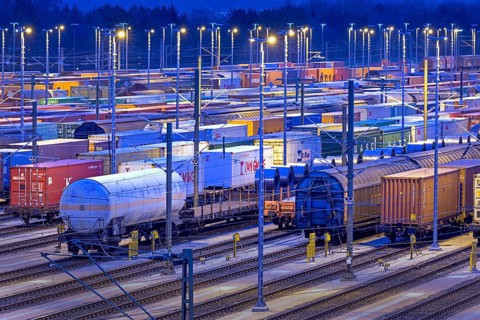 Parked freight cars on tracks at night