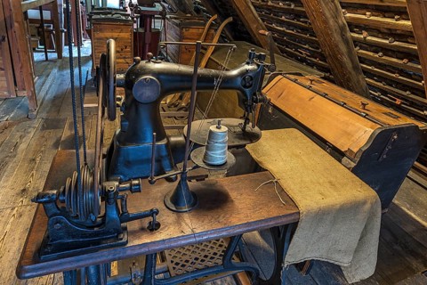 Old bag sewing machine for flour sacks in the attic of a mill