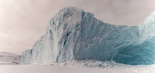Iceberg in a frozen fjord