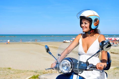 Woman on Vespa scooter