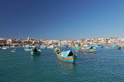 Cityscape with colorful fishing boats