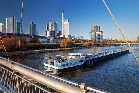 City view from Holbeinsteg with transport ship on the Main and the banking district in the background