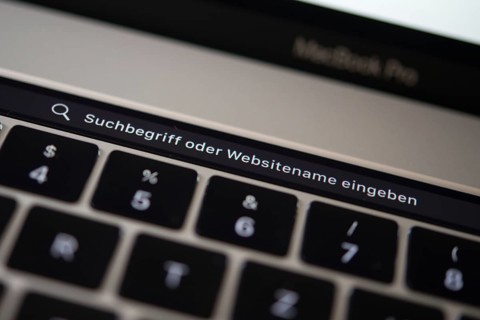 Backlit keyboard and Touch Bar showing search bar