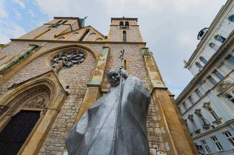 Statue of Pope John Paul II in front of the Christian Sacred Heart Cathedral