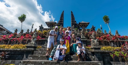 Devout Balinese posing with European tourists