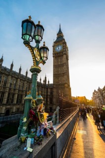 Big Ben and flowers commemorating terrorist attack on Westminster Bridge