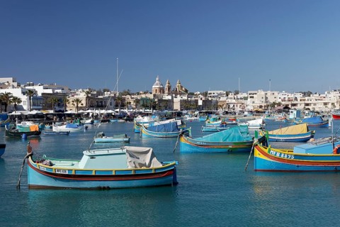 Cityscape with colorful fishing boats