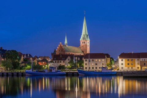 Cityscape at night with St. Olai Church at Oresund in Helsingor