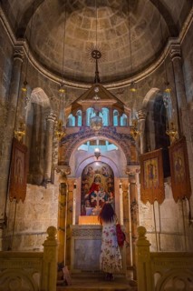 Woman praying in a side chapel of the Tomb Chapel