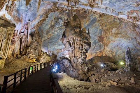 Boardwalk through illuminated dripstone cave