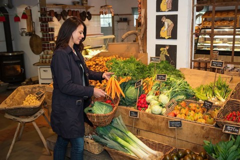 Customer buying carrots at farm shop