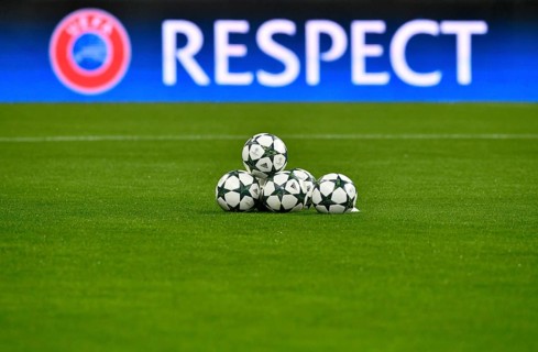 Match balls with Champions League Logo in front of UEFA perimeter advertisement