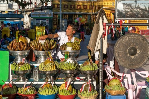 Merchant with offerings in temple complex at Golden Rock Kyaiktiyo Pagoda