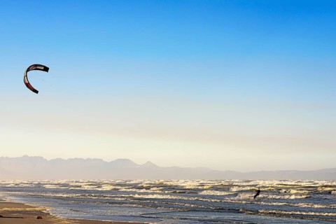 Kitesurfers at high waves
