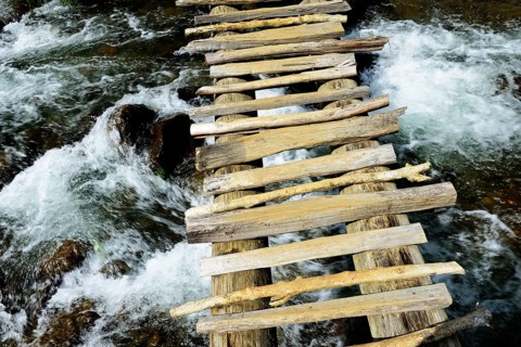 Simple wooden bridge over river
