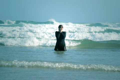 Woman in black dress with mask