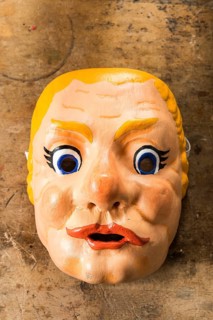 Painted wooden mask on a workbench