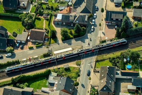 Millingen railway crossing main road with regional train
