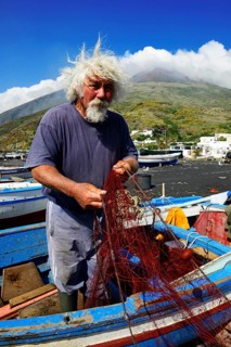 Fishermen repair nets at Scari Beach