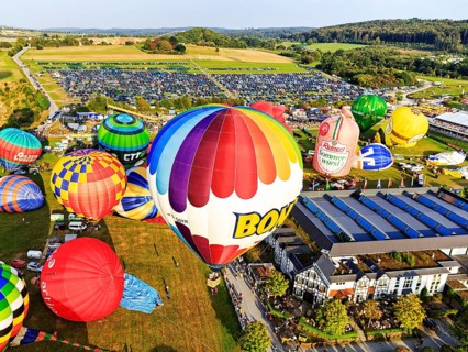 Different colored hot air balloons rising into the air