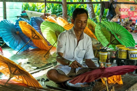 Local man working on multi-colored umbrellas