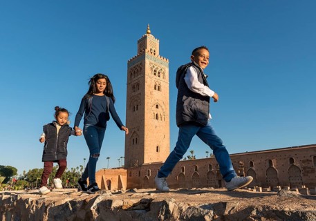 Marrocan children play outside Koutoubia Mosque