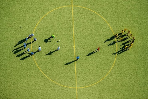 Football players at the center circle