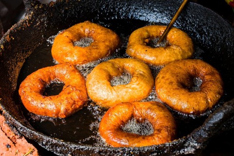 Doughnuts are fried in a pan with hot oil