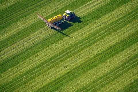 Tractor with pesticide sprayer