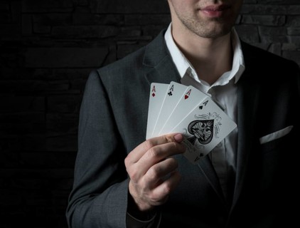 Card artist Jeremy Rowe holds playing cards in his hand