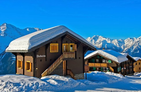 Swiss chalet with a thick layer of snow on the roof with Fletschhorn