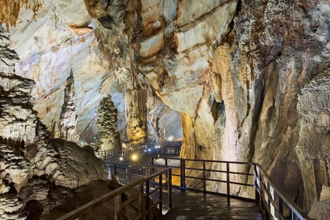 Boardwalk through illuminated dripstone cave