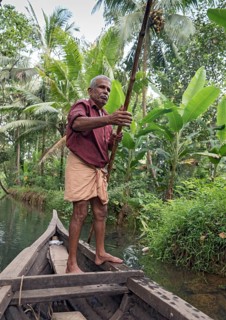 Boatman with punting pole on river