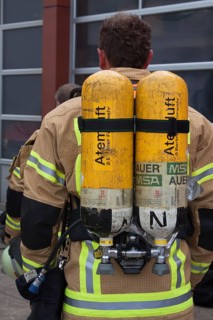 Firefighter with breathing air bottles on his back