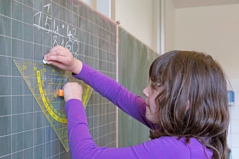 Student calculating on the blackboard