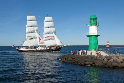 Lighthouse with sailing boat Mercedes at back