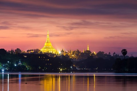 Illuminated Shwedagon Pagoda at sunset