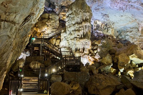 Boardwalk through illuminated dripstone cave