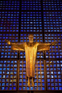 Crucifix in front of a glass facade
