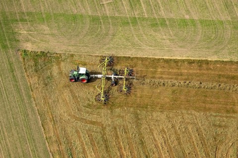 Tractor with hay rakes