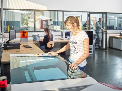 Woman in workshop with laser cutter