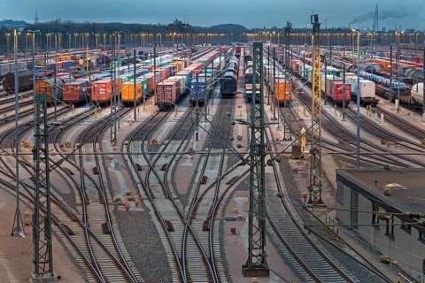 Parked freight cars on tracks at dusk