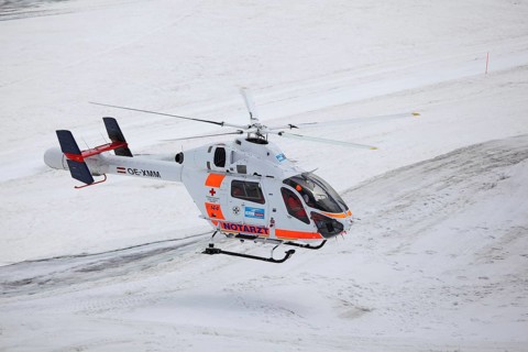 Rescue helicopter of the Austrian Red Cross in operation on the Dachstein glacier