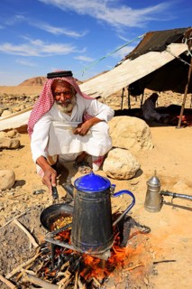 Bedouin preparing coffee with pan-roasted beans and kardamom