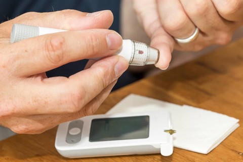 Diabetics taking a blood glucose test