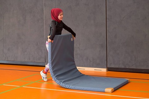 Schoolgirl wearing floor mat