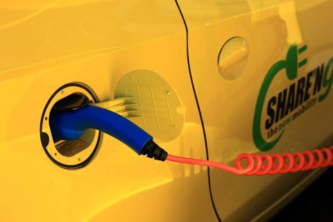 Electric car at the charging station with charging cable
