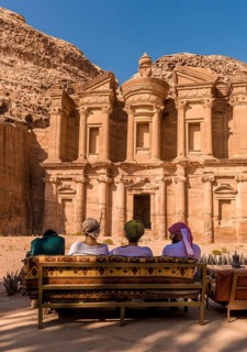 Tourists sitting on a bench