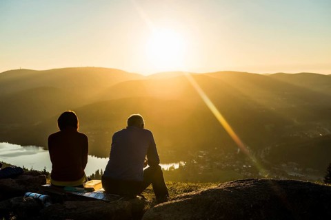 Older couple at Hochfirst with view to Titisee and Feldberg at sunset