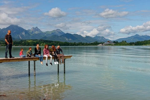 Family sitting on pier